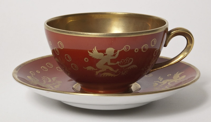 Coffee cup and saucer with putto blowing soap bubbles