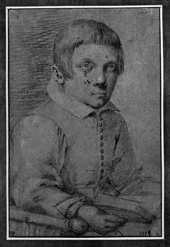 Porträtt av en pojke som sitter i en stol