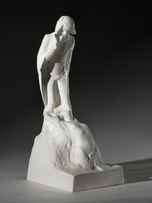 Skulptur av en man med en kvinna vid sina fötter