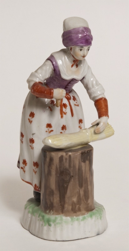 Figurin, kvinna som borstar lin