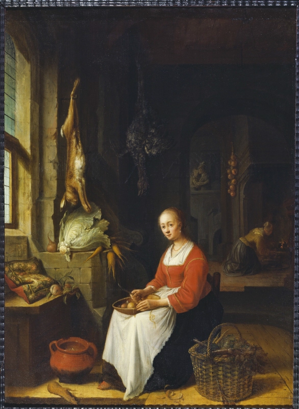 Woman Peeling Fruit in a Kitchen