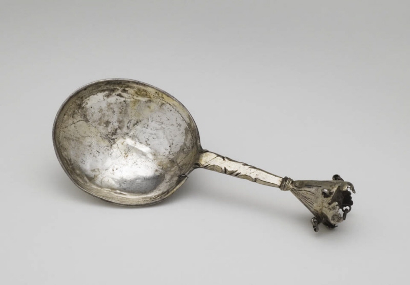 Spoon with handle terminating in a cup with erect leaves