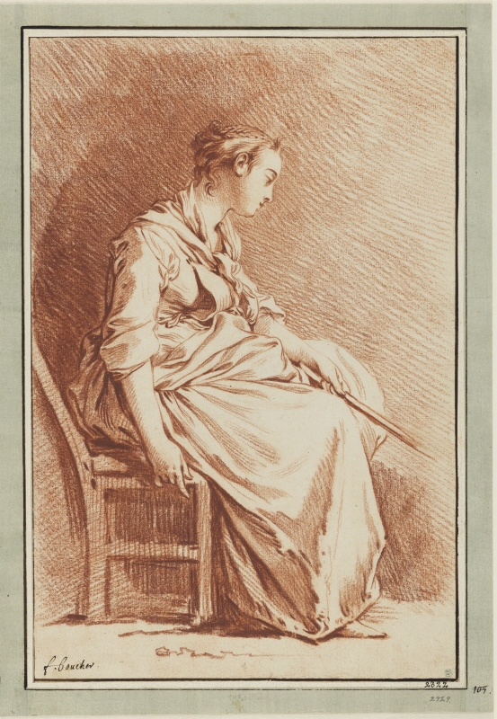 Kvinna sittande med en käpp i handen