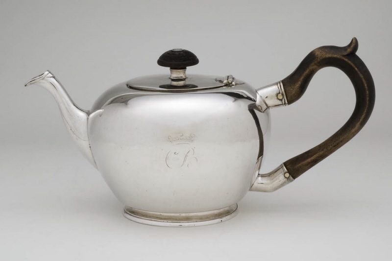 Fotted tea pot with spherical smooth body and wooden handle